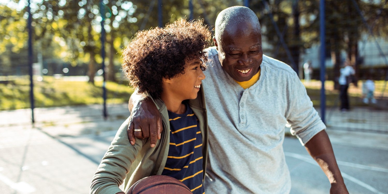 grandfather and grandson holding basketball