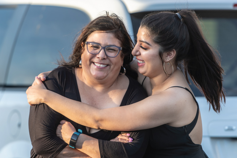 Women hugging and smiling